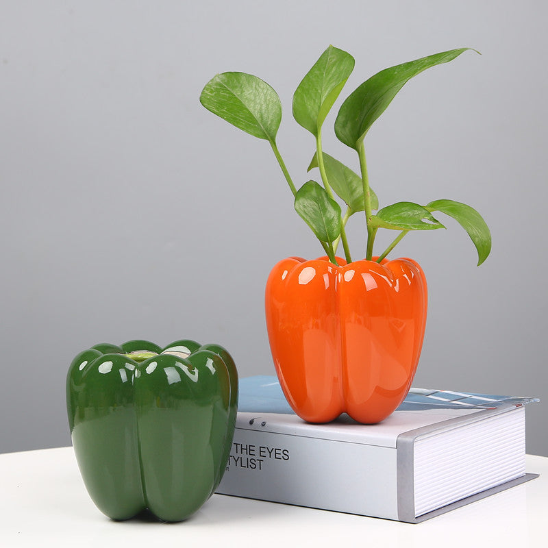 Ceramic fruit-shaped planters — pepper style in orange and green with pothos