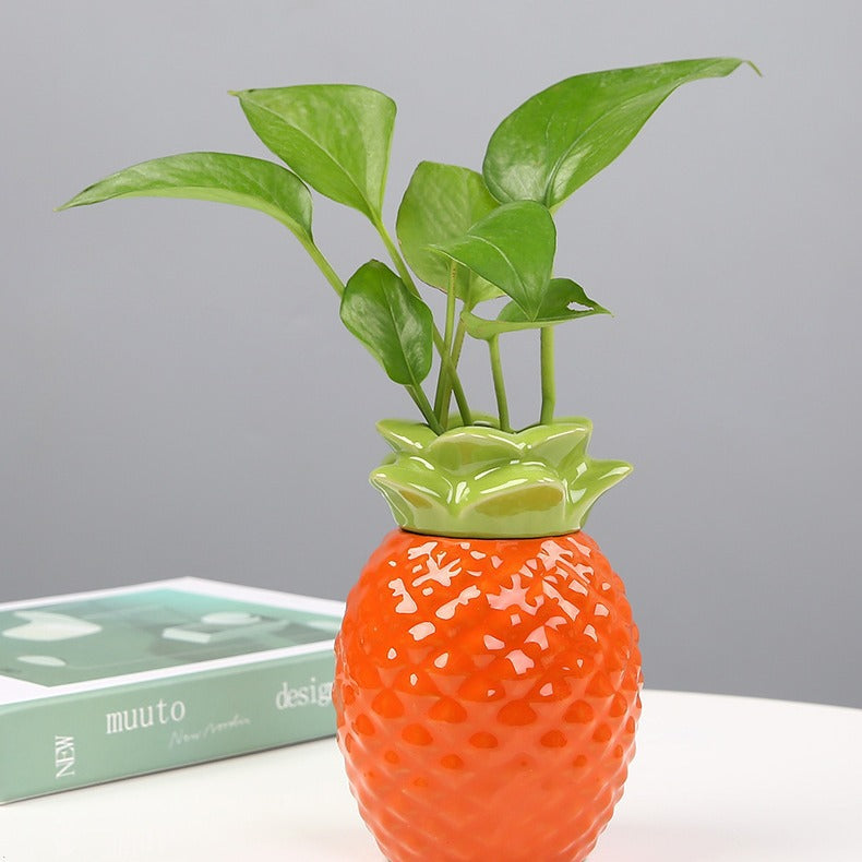Pineapple-shaped ceramic hydroponic planter — orange with green top
